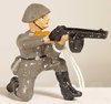 East German NVA-Soldier Kneeling Firing Submachine Gun